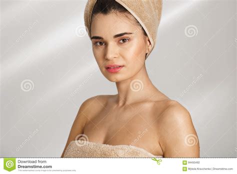 Close Up Portrait Of A Beautiful Posh Young Woman After Bath Standing Covered In Towel Stock