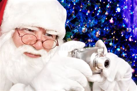Santa Claus Shoots A Digital Camera Christmas Tree In The Backgr Stock