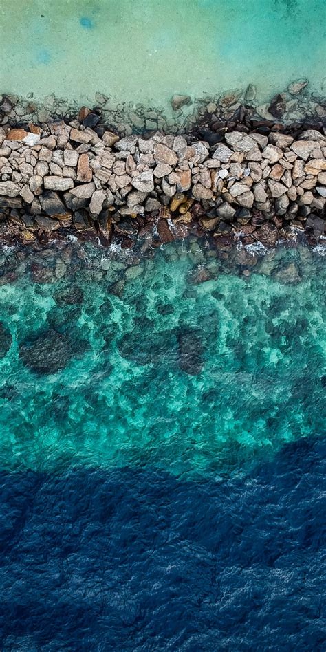Download 1080x2160 Wallpaper Blue Green Water Aerial View Rocks