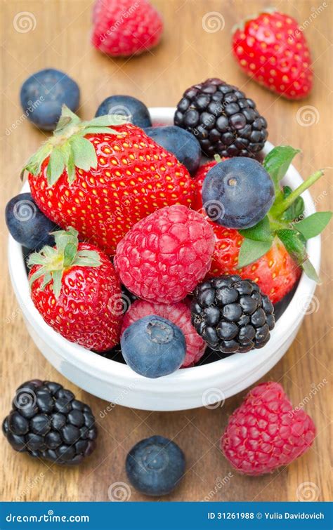Fresh Berries In A Bowl On A Wooden Background Stock Photo Image Of