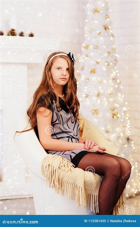 Elegant Pretty Long Haired Smiling Teen Girl In Dress In Interior With