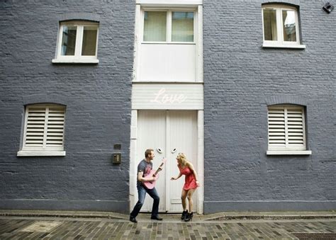 Two People Standing In Front Of A Building