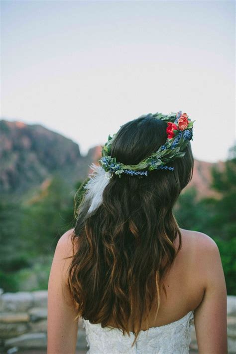 A Woman With Long Hair Wearing A Flower Crown On Top Of Her Head In