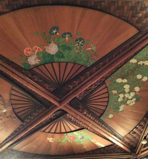 An Ornate Ceiling With Flowers And Leaves Painted On The Wood Paneling