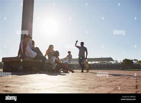 Teenage Friends Hanging Out At Sunny Skate Park Stock Photo Alamy