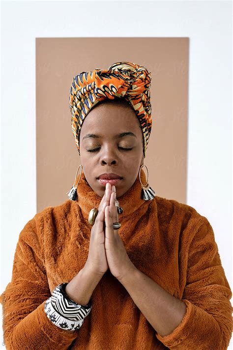 praying african american woman by stocksy contributor clique images stocksy