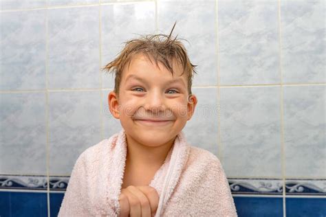 A Boy In The Shower Wrapped In A Towel A Joyful Child After Bathing