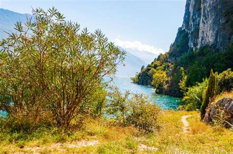 Scenic Pathway Leading To Garda Lake Shore Under The Dolomite Mountain