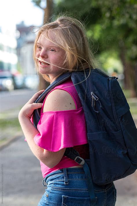 Girl With Down Syndrome Carrying A Backpack By Bowery Image Group Inc