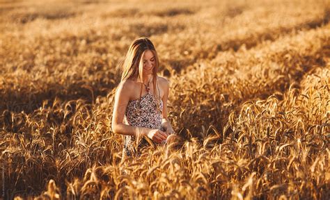 Woman In Wheat Field By Stocksy Contributor Ilya Stocksy