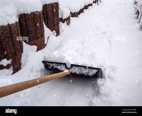 Snow Shoveling On The Sidewalk Stock Photo Alamy