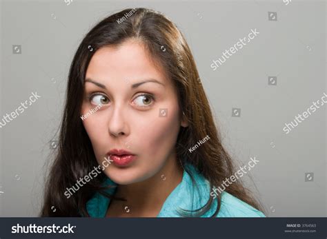Beautiful Young Brunette Woman With Facial Expression Of Surprise Excitement Embarassment Or