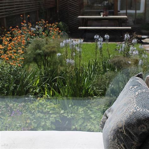 View Through Picture Window Of London Garden Designed By Miria Harris