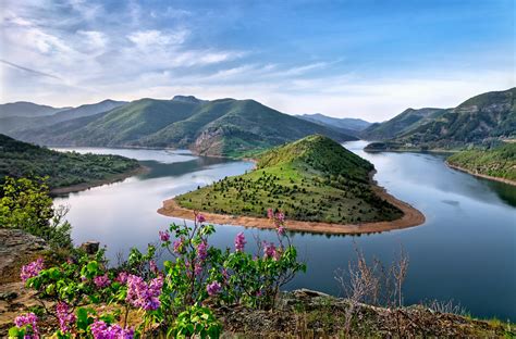 Free Photo Green Mountain Surrounded By Body Of Water Photo Outdoors