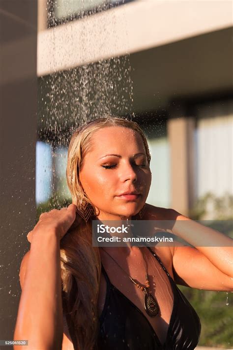 Slim Blonde Woman Taking Shower Near Pool Outdoors Stock Photo
