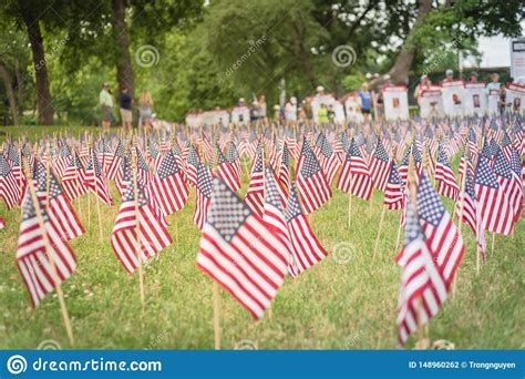 Lawn American Flags With Blurry Row Of People Carry Fallen Soldiers
