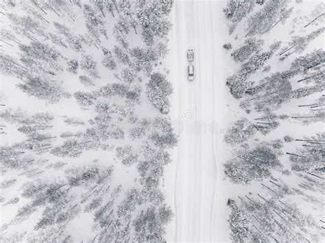 Aerial Drone View Of Winter Forest And Road Covered With Snow Stock