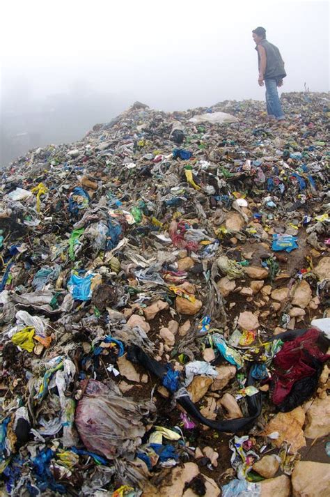Man Inspecting An Mountain Of Trash Editorial Stock Image Image Of