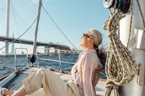 Side View Of Mature Woman Sitting On Yacht Stock Photo Image Of