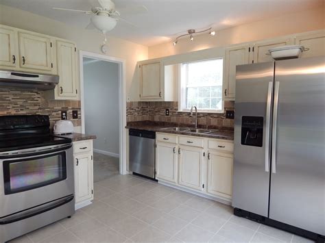 Remodeled Kitchen With Refurbished Cabinets Tile Floor And Stainless