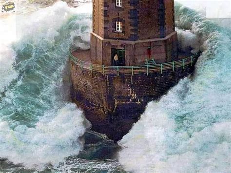 Man In Lighthouse With Wave Assuming The Rescue Chopper Had Arrived