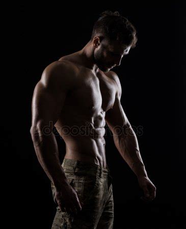 Muscular Athlete Bodybuilder Man On A Dark Background Stock Photo By Bondarchik