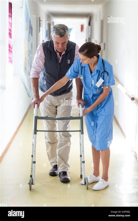 Nurse Helping Senior Patient To Walk With Walking Frame Stock Photo Alamy