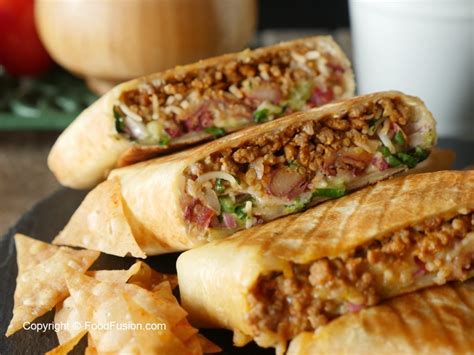 The rolls are sliced horizontally, buttered, and stuffed with the most popular mexican ingredients such as beans, avocados, ham, queso, jalapeños, and a myriad of other typical mexican dishes like fried beef or chicken, shredded beef, roasted pork, and even tamales. Mexican Burrito Wrap - Food Fusion