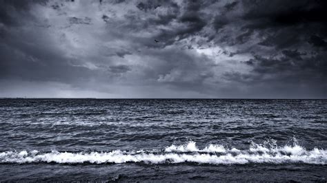Black And White Photograph Of Ocean With Storm Clouds