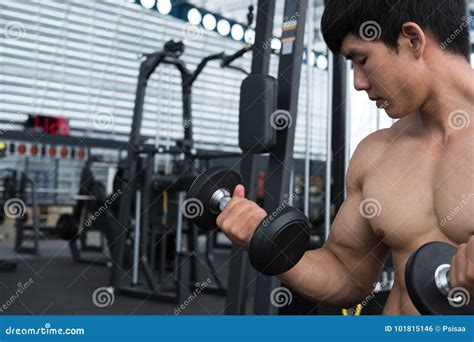 Man Lift Dumbbell In Gym Bodybuilder Male Working Out In Fitness