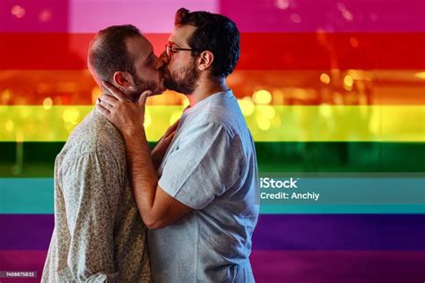 Romantic Gay Couple Kissing On The Street Lgbt Flag As Background Stock