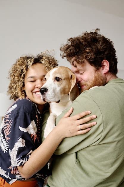Premium Photo Young Couple Loving Their Dog
