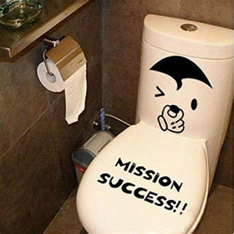 A Toilet With A Sticker On The Lid That Says Mission Success