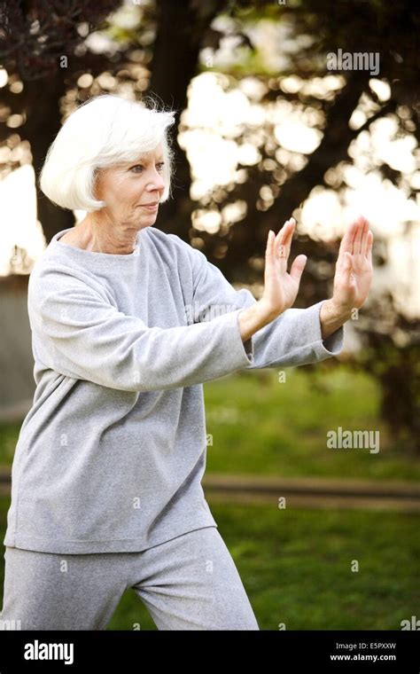 Elderly Woman Practising Tai Chi Stock Photo Alamy