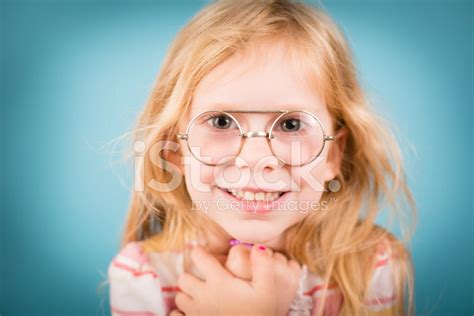 Little Girl Smiling While Wearing Vintage Nerdy Glasses Stock Photo