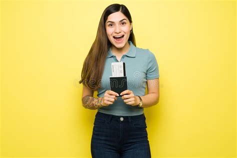 Woman Shouting With Excitement And Holding A Plane Ticket Stock Photo