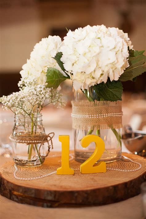 Centerpieces Of White Hydrangeas And Baby S Breath In Mason Jars