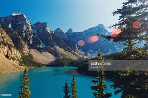 Summer Sunset At Moraine Lake Canada Surrounded By Snowcapped Peaks