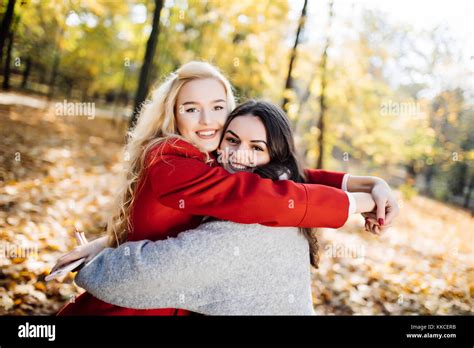 Girl Hugging Her Best Friend In The Park Stock Photo Alamy