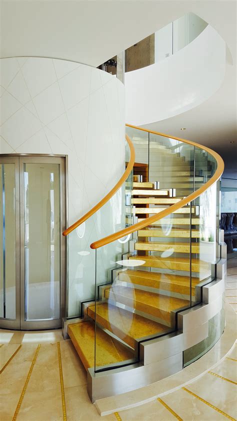 Stunning Helical Staircase Wrapping Around An Elevator Elevator Cover