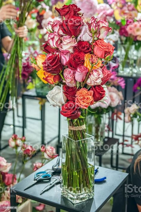 On The Table Is A Large Bouquet Of Roses Of Different Varieties And