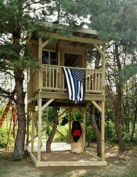Large treehouse built up in tree with lots of foliage. 35 Fellow Cops Finish the Treehouse a Slain Officer Was ...