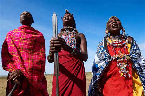 Group Of Massai Men And Women Singing And Dancing Masai Mara National