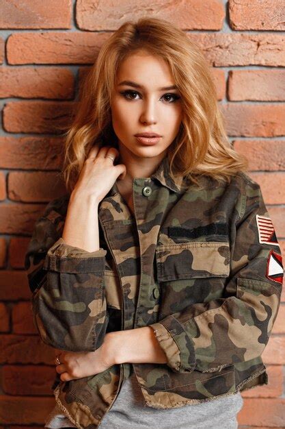 Premium Photo Beautiful Woman In Military Stylish Jacket Near Brick Wall