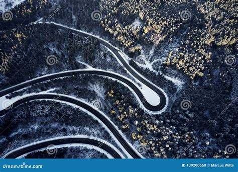 Aerial Drone View Of A Curved Winding Road Through The Forest High Up
