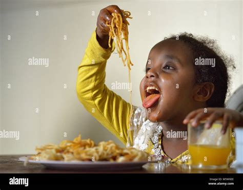 Five Year Old Saliha Mussa A Recently Arrived Refugee From Eritrea Enjoys Spaghetti For Dinner