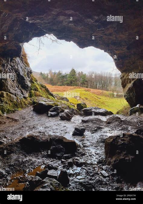 A Dark And Damp Cave Interior With A Few Scattered Rocks On The Ground