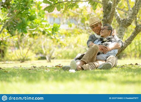 Asian Senior Elderly Retire Couple Relaxation In The Nature Park Happy
