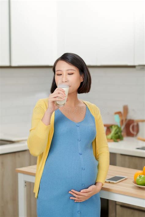 Beautiful Pregnant Woman Drinking Milk In Kitchen Stock Photo Image Of Korean Woman