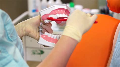 The Doctor At The Dental Clinic Demonstrates How To Properly Brush Your